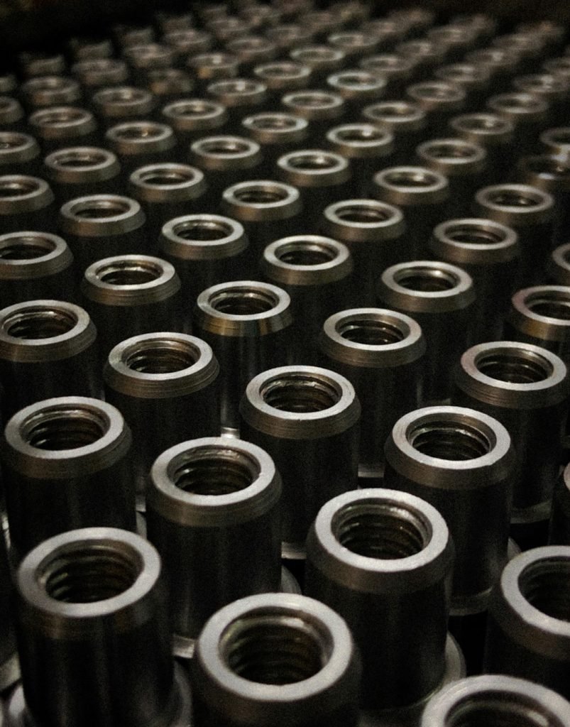 a-large-group-of-metal-flanges-sitting-on-top-of-a-table-c2s-2gmmqlw